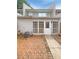 Backyard patio with brick pavers and access to the home through a white door at 1098 Eastview Ne Cir, Conyers, GA 30012