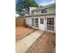 Charming backyard features a brick patio, large windows, and a white door at 1098 Eastview Ne Cir, Conyers, GA 30012