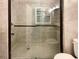 Contemporary bathroom with a glass enclosed shower, tile surround, and modern fixtures at 1098 Eastview Ne Cir, Conyers, GA 30012