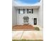 Charming two-story home with grey brick, complemented by black shutters and a manicured front yard at 1098 Eastview Ne Cir, Conyers, GA 30012