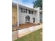 Charming two-story townhome with gray brick, black shutters, and landscaped front yard at 1098 Eastview Ne Cir, Conyers, GA 30012
