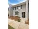 Charming two-story townhome with gray brick, black shutters, and landscaped front yard at 1098 Eastview Ne Cir, Conyers, GA 30012