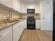 Modern kitchen with stainless steel appliances, granite countertops, and white cabinetry at 1098 Eastview Ne Cir, Conyers, GA 30012