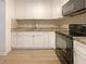 Modern kitchen featuring white cabinets, stainless steel appliances, and a subway tile backsplash at 1098 Eastview Ne Cir, Conyers, GA 30012