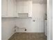 Functional laundry room with ample cabinet space and hookups for a washer and dryer at 1098 Eastview Ne Cir, Conyers, GA 30012