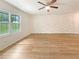 Bright living room with natural light, wood floors, and a decorative stone accent wall at 1098 Eastview Ne Cir, Conyers, GA 30012