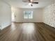 Open-concept living room with hardwood floors and a decorative stone wall at 1098 Eastview Ne Cir, Conyers, GA 30012