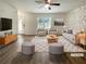 Bright, staged living room with modern furnishings, decorative stone wall, and wood-look flooring at 1098 Eastview Ne Cir, Conyers, GA 30012
