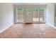 Bright sunroom with unique terracotta tile flooring and white-painted brick accents at 1098 Eastview Ne Cir, Conyers, GA 30012