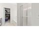 Bathroom featuring a glass-enclosed shower and a view into the walk-in closet at 305 Knights Ct, Canton, GA 30115