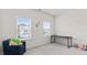 Bright bedroom featuring two windows, neutral walls, gray carpet, and a sitting chair at 305 Knights Ct, Canton, GA 30115