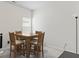 Bright dining room featuring tile flooring, a wooden table, and 4 wooden chairs at 305 Knights Ct, Canton, GA 30115