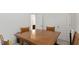 A dining room featuring gray carpet, a wood dining table, and wood chairs at 305 Knights Ct, Canton, GA 30115