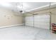 Clean garage space featuring an epoxy floor and an automatic door at 305 Knights Ct, Canton, GA 30115