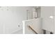 Bright hallway with white walls, carpeted floor, and a staircase leading to the upper level of the home at 305 Knights Ct, Canton, GA 30115