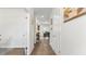 Inviting hallway with wood flooring, white walls, and doors leading to various rooms at 305 Knights Ct, Canton, GA 30115