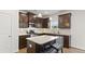 Modern kitchen with stainless steel appliances, granite countertops, and dark wood cabinets at 305 Knights Ct, Canton, GA 30115