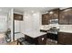 Modern kitchen with granite countertops, stainless steel appliances, and dark wood cabinets at 305 Knights Ct, Canton, GA 30115