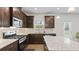 Modern kitchen with granite countertops, stainless steel appliances and dark wood cabinets at 305 Knights Ct, Canton, GA 30115