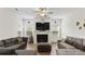 Spacious living room features a fireplace and two grey sofas with wood flooring and natural light at 305 Knights Ct, Canton, GA 30115