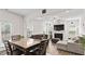 Open-concept living room with a dining table, fireplace, and comfortable seating area at 305 Knights Ct, Canton, GA 30115
