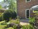 Brick house with backyard patio, lush landscaping, and shade; ideal for outdoor entertaining at 4360 Pleasant Forest Dr, Decatur, GA 30034
