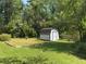 Backyard featuring a storage shed and open grassy area, perfect for outdoor activities at 4360 Pleasant Forest Dr, Decatur, GA 30034