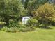Charming backyard shed surrounded by lush landscaping and mature trees, creating a serene retreat at 4360 Pleasant Forest Dr, Decatur, GA 30034