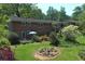 Brick home with a spacious backyard, patio with table and seating, and lush landscaping at 4360 Pleasant Forest Dr, Decatur, GA 30034