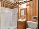 Bathroom with wood paneling features shower, vanity, and toilet at 4360 Pleasant Forest Dr, Decatur, GA 30034