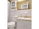 Bathroom with white tile walls and vanity with marble counter top, toilet, and medicine cabinet at 4360 Pleasant Forest Dr, Decatur, GA 30034