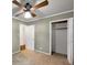 Bedroom with green walls and neutral carpet and lighted ceiling fan has open closet at 4360 Pleasant Forest Dr, Decatur, GA 30034