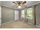 Bedroom with gray walls and neutral carpet and lighted ceiling fan has natural light from two curtained windows at 4360 Pleasant Forest Dr, Decatur, GA 30034