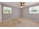 Bright and airy bedroom featuring neutral walls, carpeted floors, two windows and a ceiling fan at 4360 Pleasant Forest Dr, Decatur, GA 30034