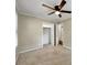 Bedroom with beige walls and carpet and lighted ceiling fan with view into closet and doorway at 4360 Pleasant Forest Dr, Decatur, GA 30034