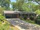 Ranch home with long driveway, covered parking, manicured lawn, and mature trees at 4360 Pleasant Forest Dr, Decatur, GA 30034
