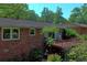 Rear exterior view featuring a brick home with new windows and a wood deck at 4360 Pleasant Forest Dr, Decatur, GA 30034