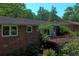 Rear exterior view featuring a brick home with new windows and a wood deck at 4360 Pleasant Forest Dr, Decatur, GA 30034