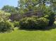 Exterior view with a brick facade, upper deck, and mature landscaping on an expansive lawn at 4360 Pleasant Forest Dr, Decatur, GA 30034
