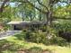 Landscaped front yard with mature trees, offering privacy and curb appeal to this charming home at 4360 Pleasant Forest Dr, Decatur, GA 30034
