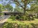 Charming single-story home with mature landscaping and a covered carport at 4360 Pleasant Forest Dr, Decatur, GA 30034