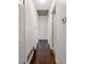 Hallway with white walls and hardwood floors with closed white doors on either side at 4360 Pleasant Forest Dr, Decatur, GA 30034