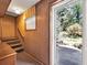 Interior stairwell with wood paneling leads to the backyard at 4360 Pleasant Forest Dr, Decatur, GA 30034