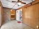 Cozy sunroom with tile floor, wood paneling, ceiling fan and adjacent kitchen view at 4360 Pleasant Forest Dr, Decatur, GA 30034