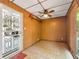 Enclosed sunroom with wood paneling, ceiling fan, and tile flooring at 4360 Pleasant Forest Dr, Decatur, GA 30034