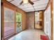 Sunroom featuring wood paneling, ceiling fan, and sliding glass door at 4360 Pleasant Forest Dr, Decatur, GA 30034