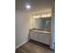 Bathroom featuring a double vanity with granite counters and wood-look floors at 6424 Rosetta Dr, South Fulton, GA 30331