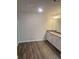 Bathroom featuring a double vanity with granite counters and wood-look floors at 6424 Rosetta Dr, South Fulton, GA 30331