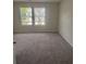 Bedroom featuring neutral carpet and two windows for natural light at 6424 Rosetta Dr, South Fulton, GA 30331