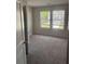 Bedroom featuring neutral carpet and two windows for natural light at 6424 Rosetta Dr, South Fulton, GA 30331